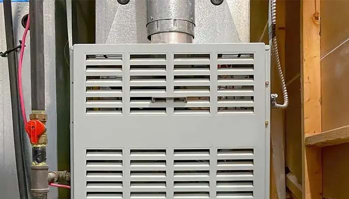 A close-up view of a homeowner or HVAC technician adjusting a smart thermostat, illustrating how intelligent temperature control and modern HVAC technology.