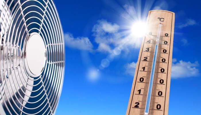 HVAC technician inspecting an outdoor air conditioning unit during humid summer weather.