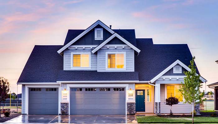Technician installing a high-efficiency central air conditioning unit outside a 3,000-square-foot home.