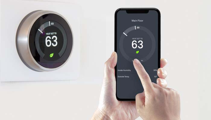 A Nest smart thermostat installed in a contemporary home