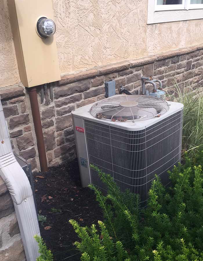 Bryant Heating & Cooling technician performing an AC compressor replacement